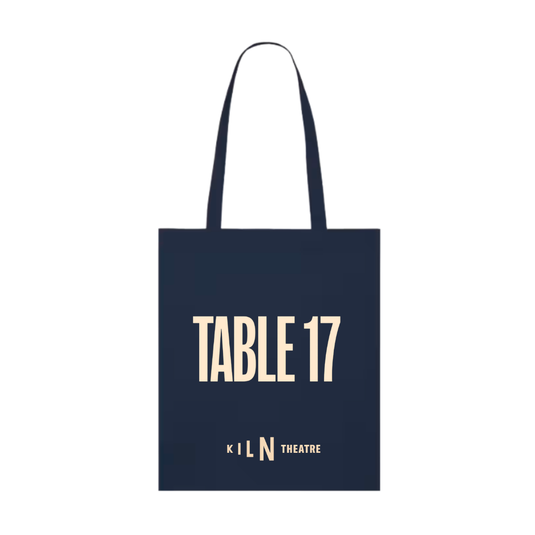A navy blue canvas tote bag with long handles, featuring the text 'TABLE 17' in a light cream serif font and 'KILN THEATRE' in a smaller matching font below it, shown on a plain white background.