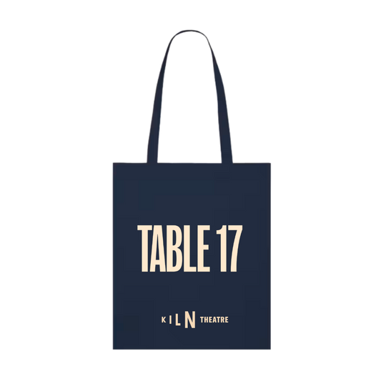 A navy blue canvas tote bag with long handles, featuring the text 'TABLE 17' in a light cream serif font and 'KILN THEATRE' in a smaller matching font below it, shown on a plain white background.